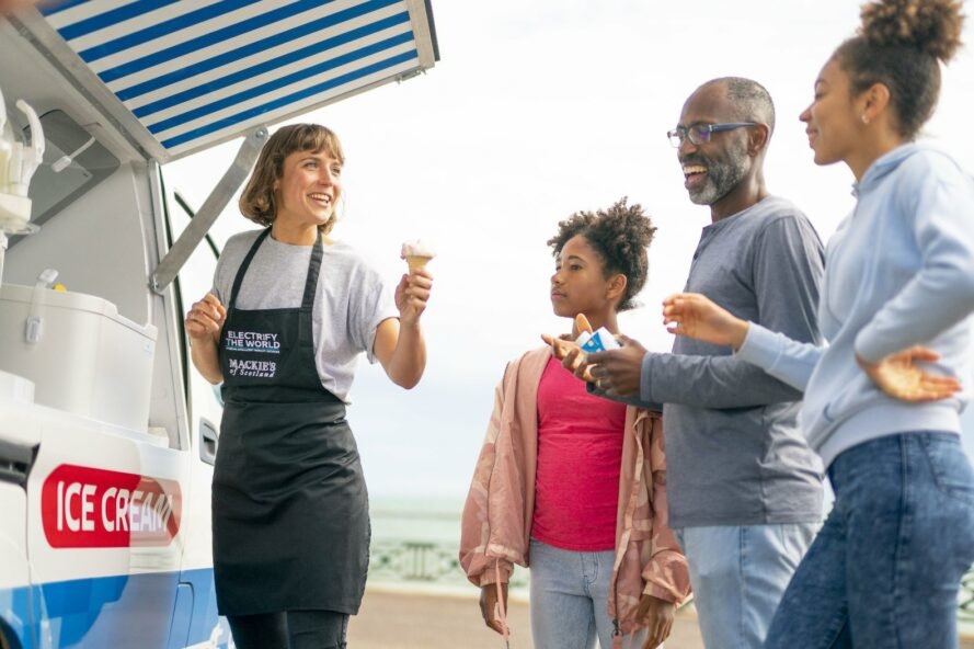 woman selling ice cream to three people