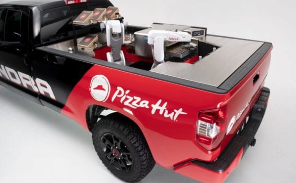 a red and black pickup truck with a pizza kitchen in the back
