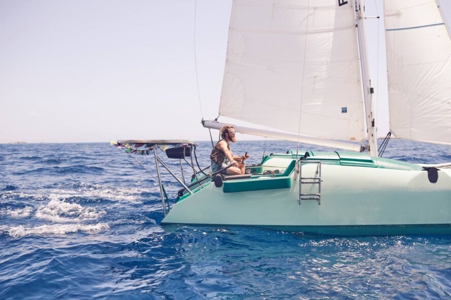 person on green sail boat