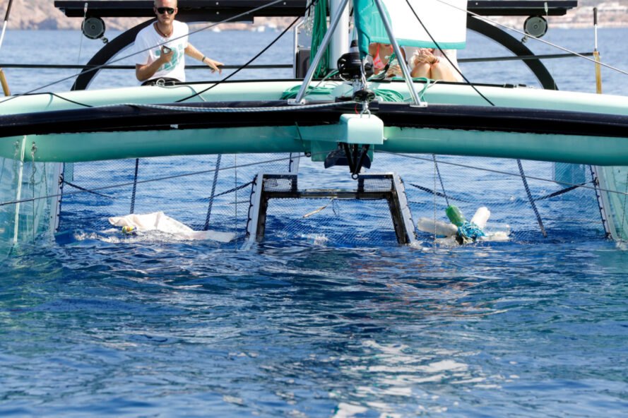 boat with clean-up net in the ocean