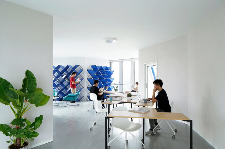 people reading at tables in a shared room