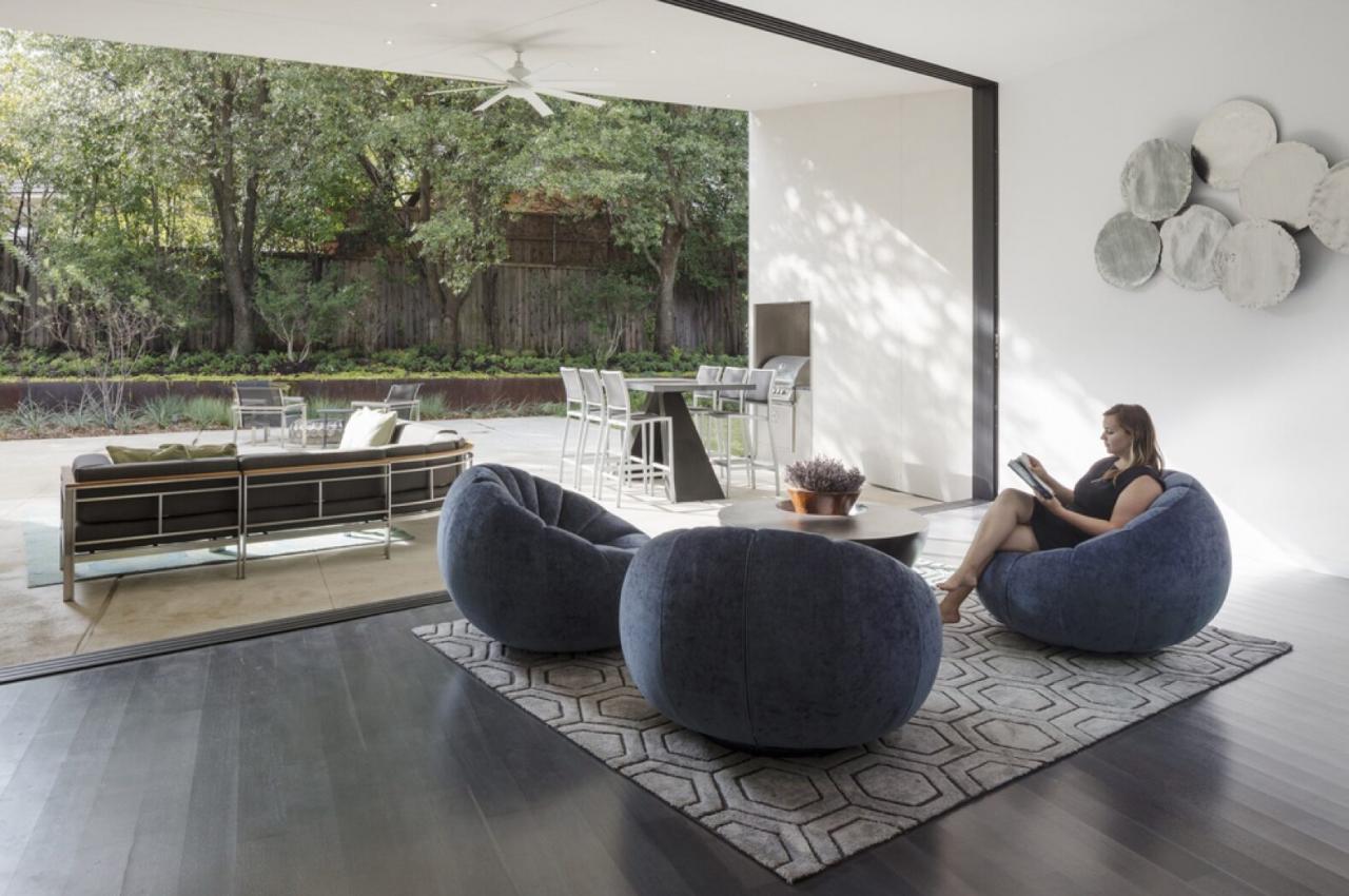 living area with round, gray chairs near a glass wall