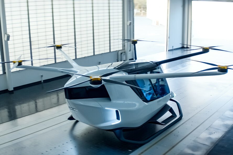 rendering of white aircraft inside a hangar
