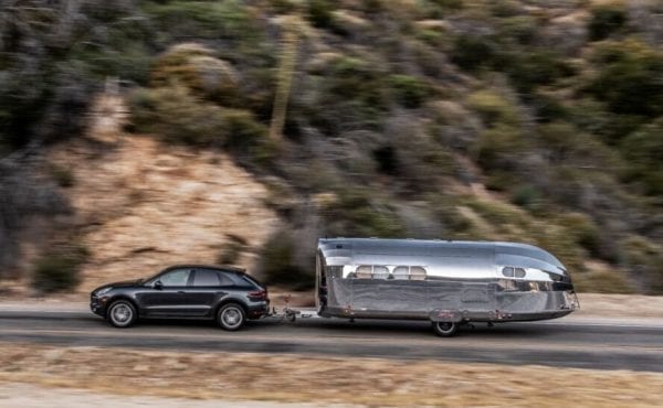 SUV pulling a silver travel trailer