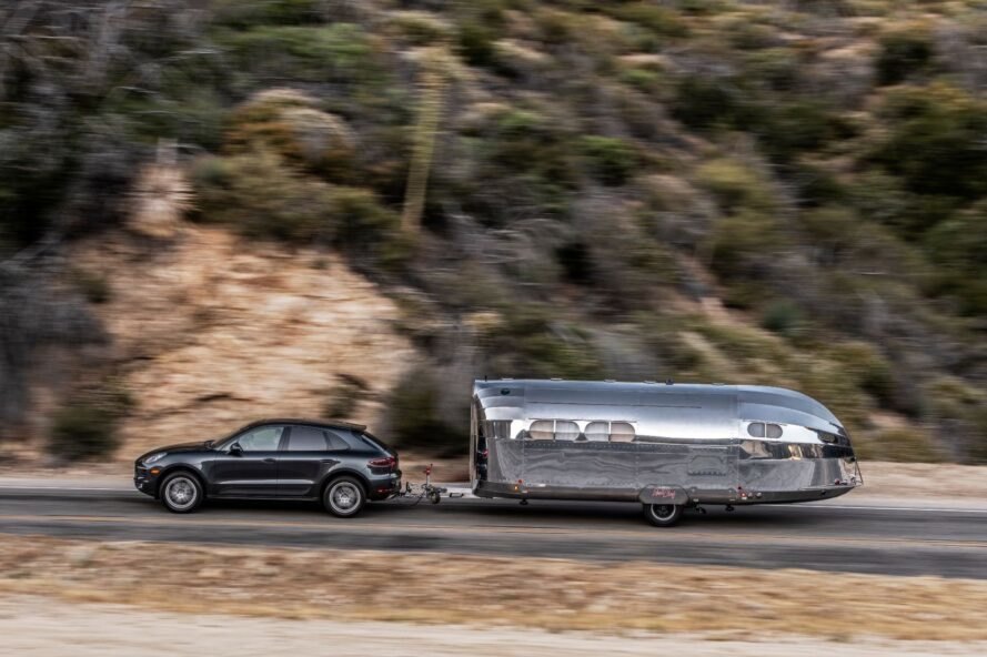 SUV pulling a silver travel trailer