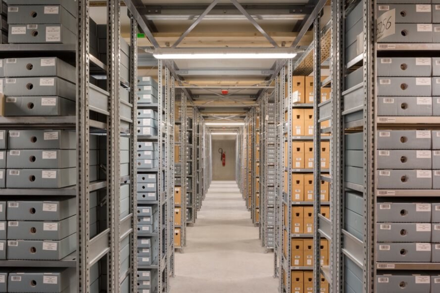 room with several aisles of archives on shelves