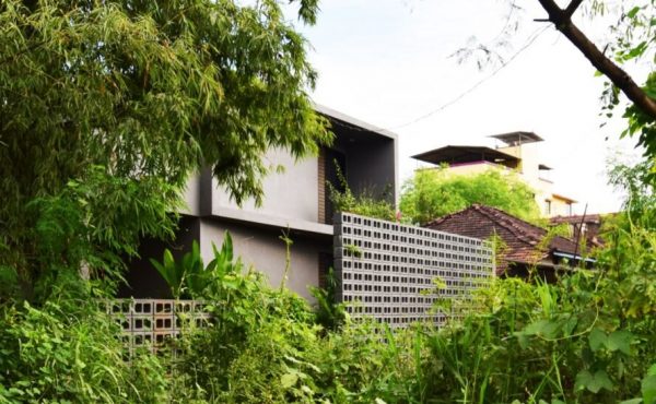 concrete home tucked into greenery