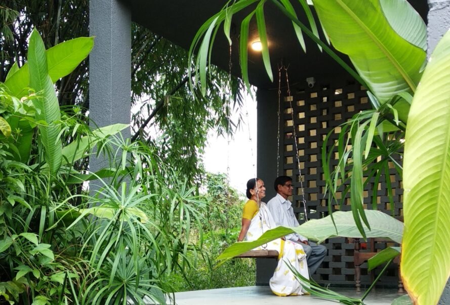 two people seated on outdoor balcony