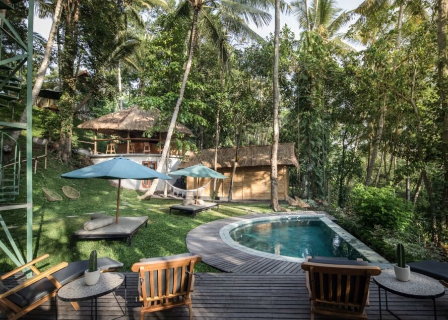 an outdoor area with deck and small pool