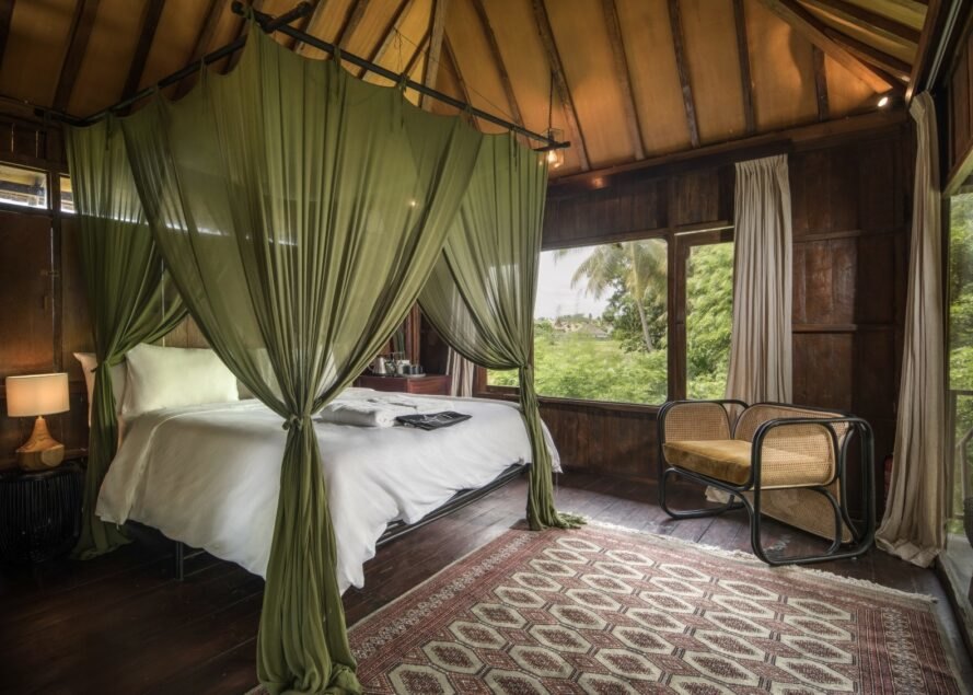 large white bed with mosquito netting